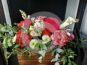 Flowers cute bouquet with roses and alstroemerias pink white green, wooden box photo