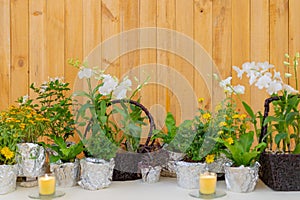 Flowers decorate on the dinning long table in the luxury relax event with the wood plate background