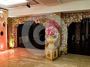 Flowers decoration inside indian wedding banquet hall during evening time in Delhi India