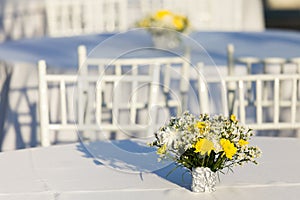 Flowers decoration on white table outdoor in  wedding reception
