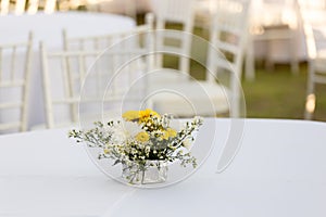 Flowers decoration on white table outdoor in  wedding reception