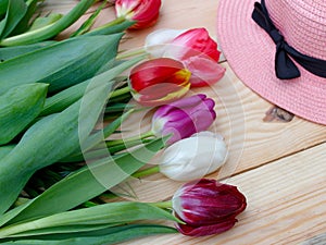 Tulips and easter eggs on a white background. Flowers of different colors. The concept of spring, the awakening of nature. Postcar