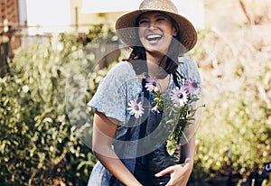 Flowers, gardening and woman with plant in outdoor for environment, sustainability or ecology. Nature, laughing and