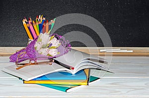 Flowers and gift; copybooks on the teacher's desk.