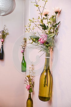 Flowers in hanging bottles