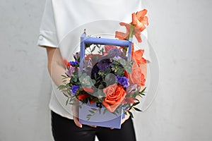 flowers in hat box. woman with a bouquet of flowers. online catalog of flower delivery shop. plant composition