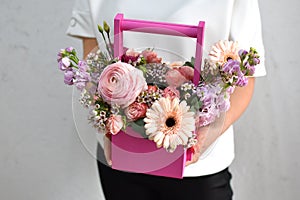 flowers in hat box. woman with a bouquet of flowers. online catalog of flower delivery shop. plant composition