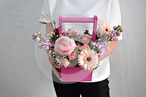 flowers in hat box. woman with a bouquet of flowers. online catalog of flower delivery shop. plant composition