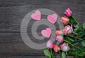 Flowers and hearts on a wooden background