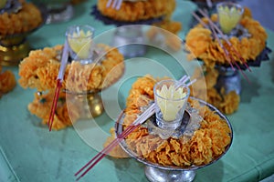 Flowers, incense, candles, pay homage to Buddhist beliefs