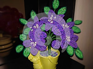 Flowers jewelry beads in pots on a dark background