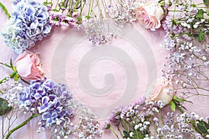 flowers laing in pink paper in heart shape