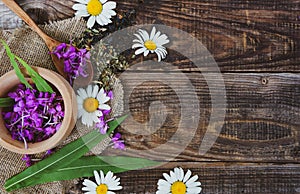 Flowers and leaves of ivan chamomile tea on a wooden rustic table, Epilobium angustifolium. Fireweed Rosebay Willowherb, pink fl