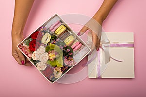 Flowers and macaroons in a hat-box