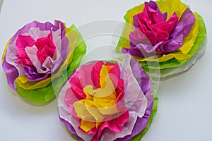 Three colorful tissue paper flowers