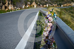 Flowers memorial symbol in a road