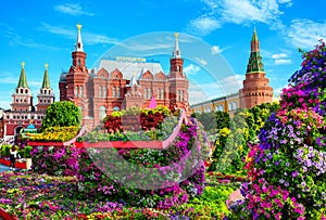 Flowers in Moscow, Russia. Scenic view of Historical Museum it`s written on roof and Moscow Kremlin in background