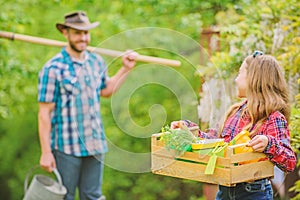 Flowers need my care. little girl and happy man dad. earth day. spring village country. family farm. ecology. Gardening