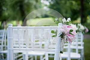 Flowers on outdoor wedding chairs