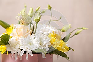 Flowers in a pink box close-up with a blurred background. Flowers as a gift, chrysanthemums, roses, as a background