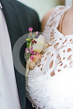 Flowers in the pocket of his jacket at the wedding