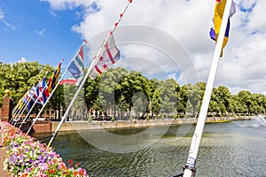 Flowers and provincial flags at the pond in Den Haag