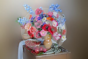 Flowers.Red poppies , cornflowers and daisies in a vase.Ripe berries,plum