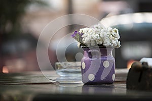 Flowers in retro bucket on wooden table