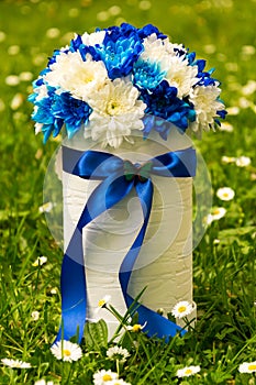 Flowers in a romantic gift box on the grass. Symbol of love