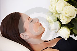 Flowers, roses and woman sleeping in bedroom for resting, relax and peaceful with eyes closed. Flower bouquet, love and