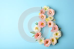Flowers in the shape of number 8 on a colored background with place for text