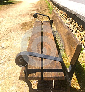 Nice spring in the Spain, wooden bench in city park photo