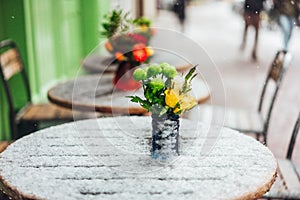 Flowers stand on a snowy table