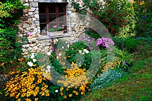 Flowers and stone-built house