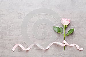 Flowers valentine day composition. Frame made of pink rose on gray background. Flat lay, top view, copy space