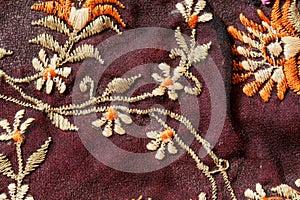 Flowers of vintage carpet stitching thread in old-style craftmenship style.