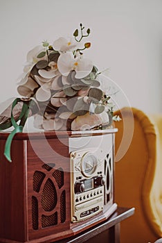 Flowers on a vintage wooden radio with white background