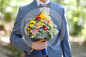 Flowers, wedding, bouquet in male hand for wedding ceremony 