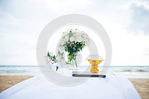 Flowers at a wedding ceremony on the beach.