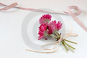 Flowers on white textured wood background