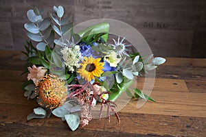 Flowers with wooden background and wooden table