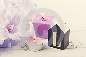 Flowers and wooden letter L on white table