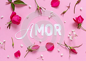 Flowers and word AMOR on a light pink background