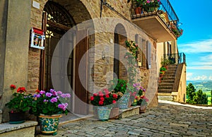 Flowery entrance and street view in Tuscany, Pienza, Italy