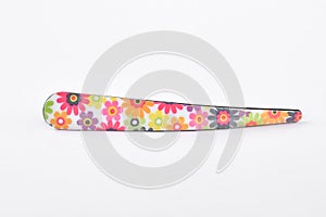 Flowery hair clip on white background.