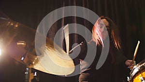 Flowing black hair - beauty girl plays drum rock at garage