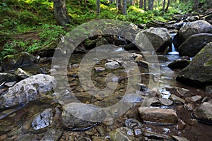 Flowing mountain stream and stones