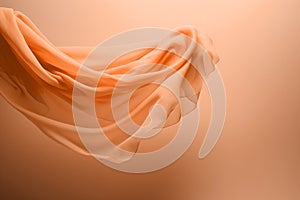 A flowing peach fuzz color fabric on soft minimal background
