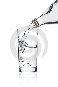 Flowing pure water into glass on white background