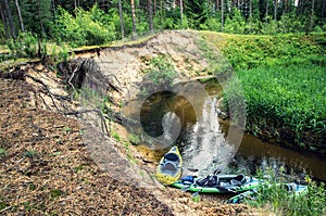 Flowing river and canoes on the shore